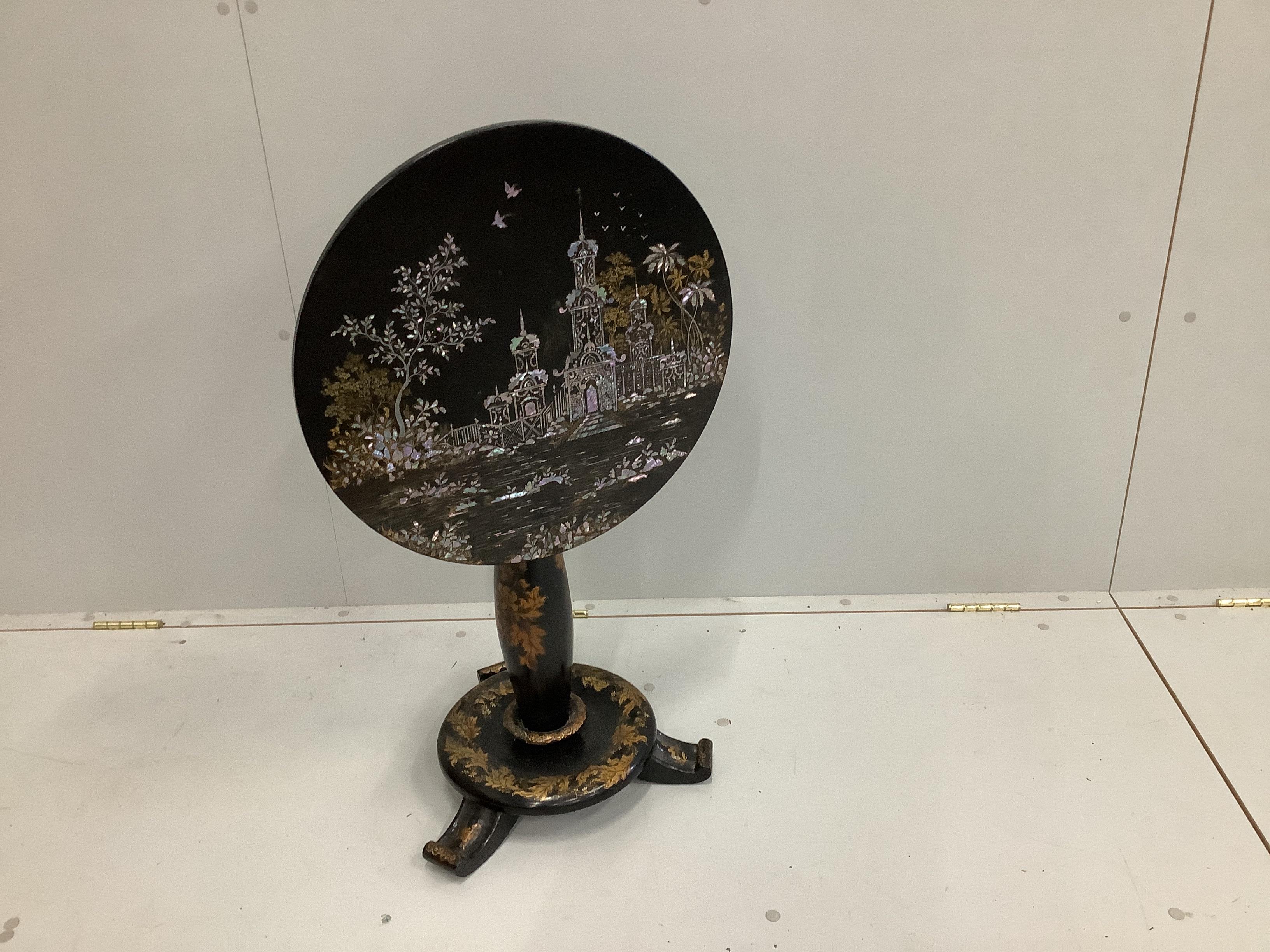 A Victorian black lacquered papier mache occasional table, with circular tile top, chinoiserie decoration and mother of pearl inlay, on single column, diameter 48cm, height 57cm